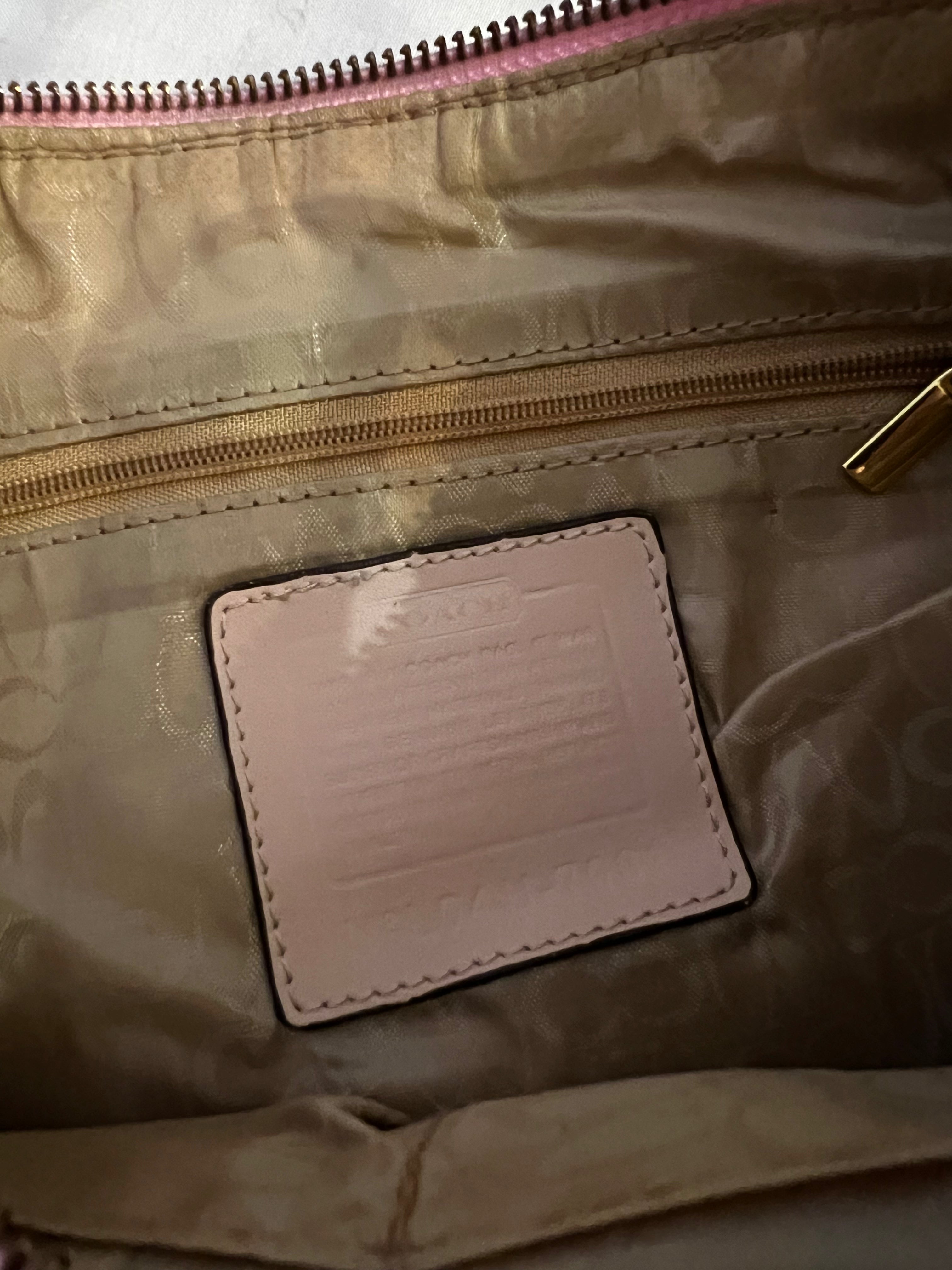 Close-up of a beige bag with a visible brand label.